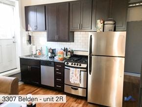 Chicago apartment for rent - a kitchen with stainless steel appliances and black cabinets