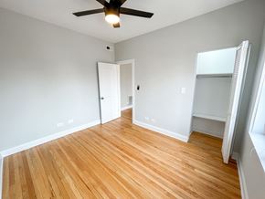 Chicago apartment for rent - an empty living room with wood flooring and a ceiling fan