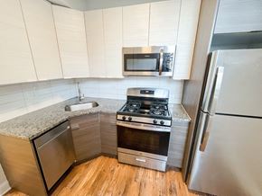 Chicago apartment for rent - a small kitchen with stainless steel appliances and a counter top