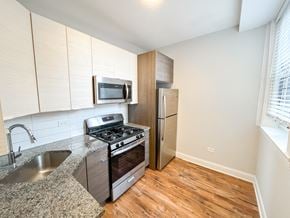 Chicago apartment for rent - a kitchen with stainless steel appliances and a granite counter top