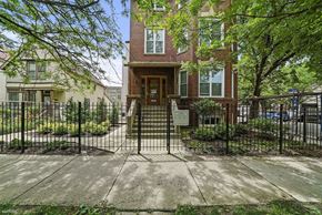 Chicago apartment for rent - the front of a house with a gate and a sidewalk