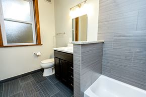 Chicago apartment for rent - A bathroom with a toilet, sink, and tub.
