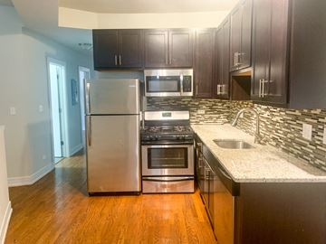 Chicago apartment for rent - a kitchen with stainless steel appliances and granite counter tops