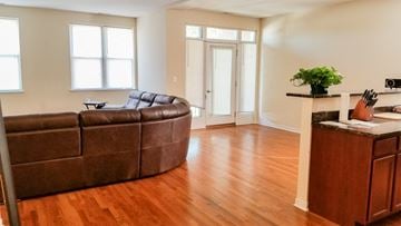 Chicago apartment for rent - a living room with a leather couch and a wooden floor