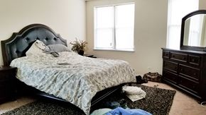 Chicago apartment for rent - a bedroom with a bed and clothes on the floor