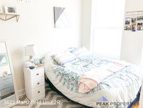 Chicago apartment for rent - a small bedroom with a bed and a dresser