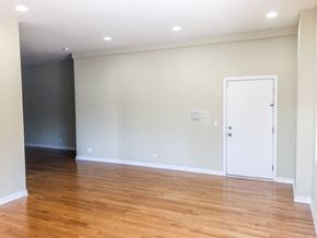 Chicago apartment for rent - a living room with white walls and wood floors