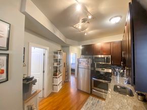 Chicago apartment for rent - A kitchen with a refrigerator, oven, and microwave.