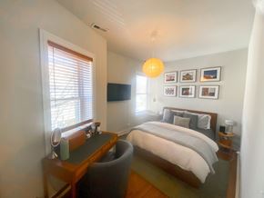 Chicago apartment for rent - A bedroom with a bed, desk, and chair.