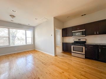 Chicago apartment for rent - A kitchen with a microwave, oven, and stove top.