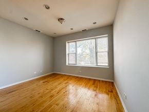Chicago apartment for rent - A room with wooden flooring and a window.