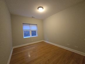 Chicago apartment for rent - A room with wooden flooring and a window.