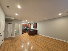 Chicago apartment for rent - A kitchen with wooden floors and white walls.