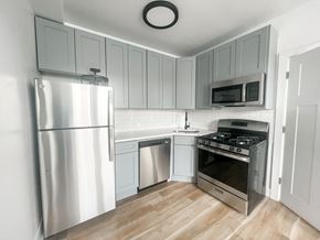 Chicago apartment for rent - A modern kitchen with a stainless steel refrigerator, oven, and microwave.