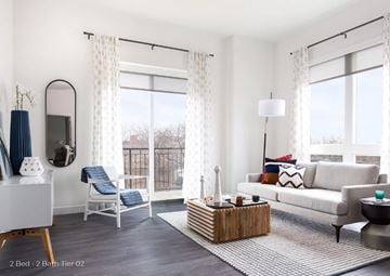 Chicago apartment for rent - a living room with a couch and a rug and windows