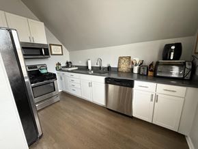 Chicago apartment for rent - A kitchen with white cabinets and stainless steel appliances.