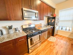 Chicago apartment for rent - a kitchen with stainless steel appliances and wooden cabinets