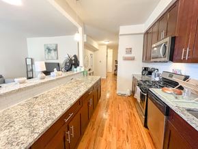 Chicago apartment for rent - a large kitchen with granite counter tops and wood floors