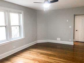 Chicago apartment for rent - A room with a ceiling fan and a window.