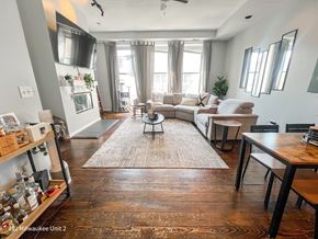 Chicago apartment for rent - A living room with a couch, a chair, a coffee table, and a rug.