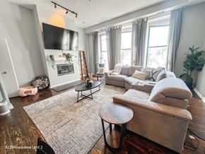 Chicago apartment for rent - A living room with a couch, coffee table, and fireplace.