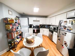 Chicago apartment for rent - A kitchen with a table and chairs and a pineapple on the table.