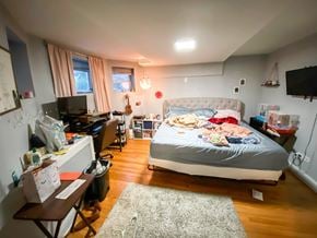 Chicago apartment for rent - A bedroom with a bed, desk, and chair.