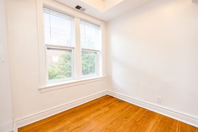 Chicago apartment for rent - A room with a window and wooden floors.