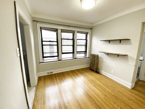 Chicago apartment for rent - A room with a window and a radiator on the wall.
