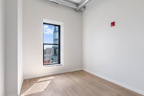 Chicago apartment for rent - A room with a window showing a view of a building outside.