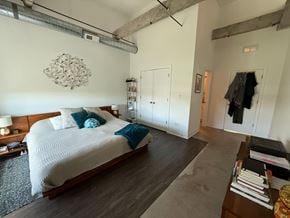 Chicago apartment for rent - A bedroom with a large bed and a wooden floor.