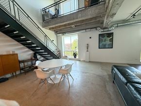 Chicago apartment for rent - A living room with a staircase and a couch.