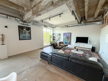 Chicago apartment for rent - A living room with a black couch and a television.