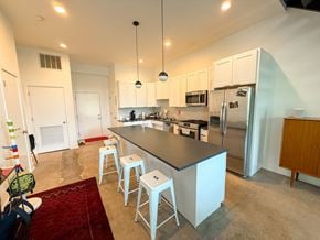 Chicago apartment for rent - A kitchen with a bar area and white cabinets.