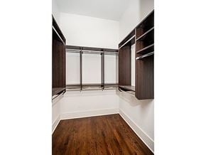 Chicago apartment for rent - A room with a wood floor and a wall of shelves.