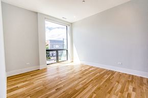 Chicago apartment for rent - an empty living room with wood flooring and a balcony
