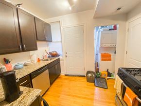 Chicago apartment for rent - a kitchen with a door to a closet and a stove and a sink