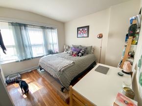 Chicago apartment for rent - a bedroom with a bed and a desk and a window