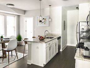 Chicago apartment for rent - a white kitchen with a large island and a dining room
