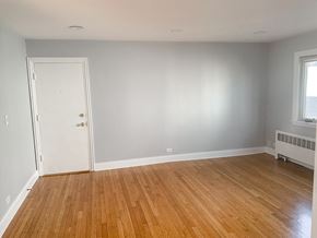 Chicago apartment for rent - an empty room with a wooden floor and a white door
