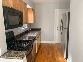 Chicago apartment for rent - a kitchen with granite counter tops and a stove and a refrigerator