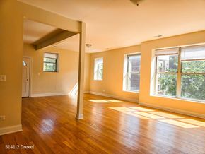 Chicago apartment for rent - an empty living room with a hard wood floor and large windows