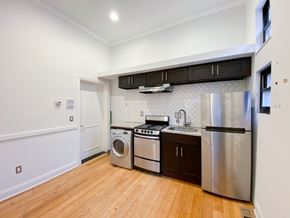 Chicago apartment for rent - A kitchen with wooden floors and stainless steel appliances.
