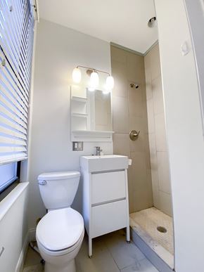 Chicago apartment for rent - A white toilet sits next to a sink in a small bathroom.