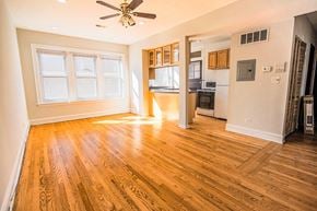 Chicago apartment for rent - A room with wooden floors and a ceiling fan.