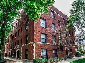 Chicago apartment for rent - a red brick building with trees in front of it