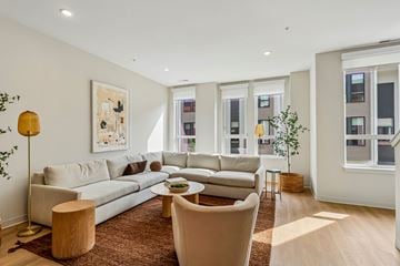 Rocky River townhouse for rent - A living room with a large sectional sofa and a coffee table.