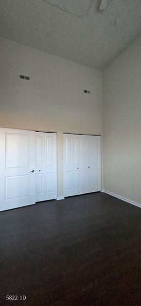 Chicago apartment for rent - A room with two white doors and a dark floor.
