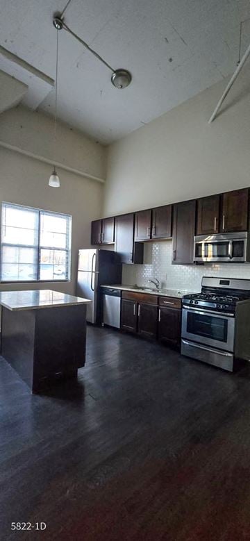 Chicago apartment for rent - A kitchen with a stove top oven and a refrigerator.