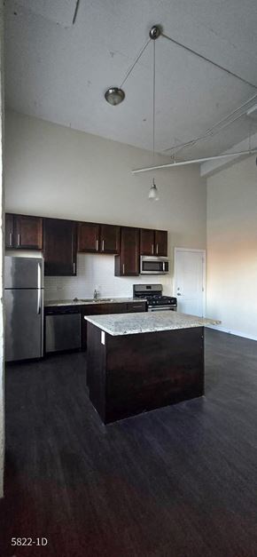 Chicago apartment for rent - A kitchen with a refrigerator, microwave, and oven.